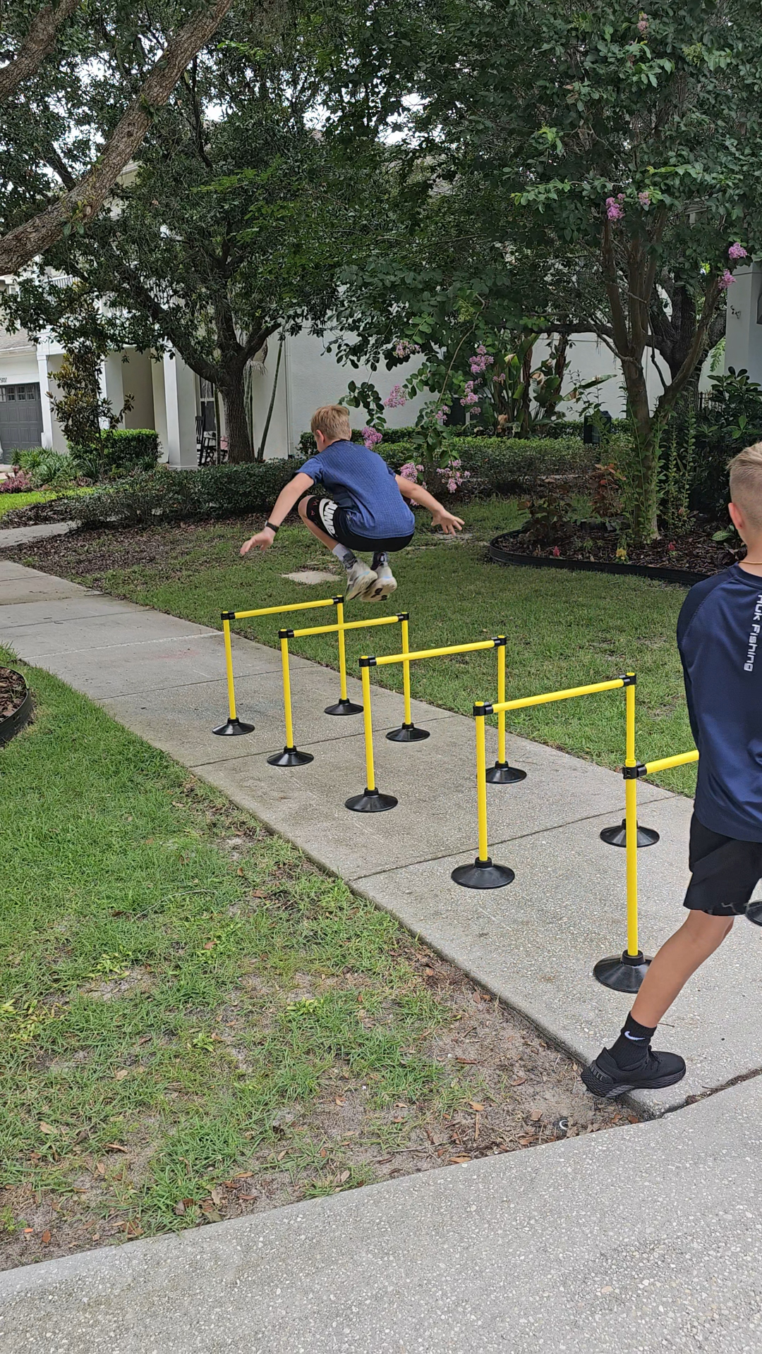Young athletes running hurdle drills for agility and power