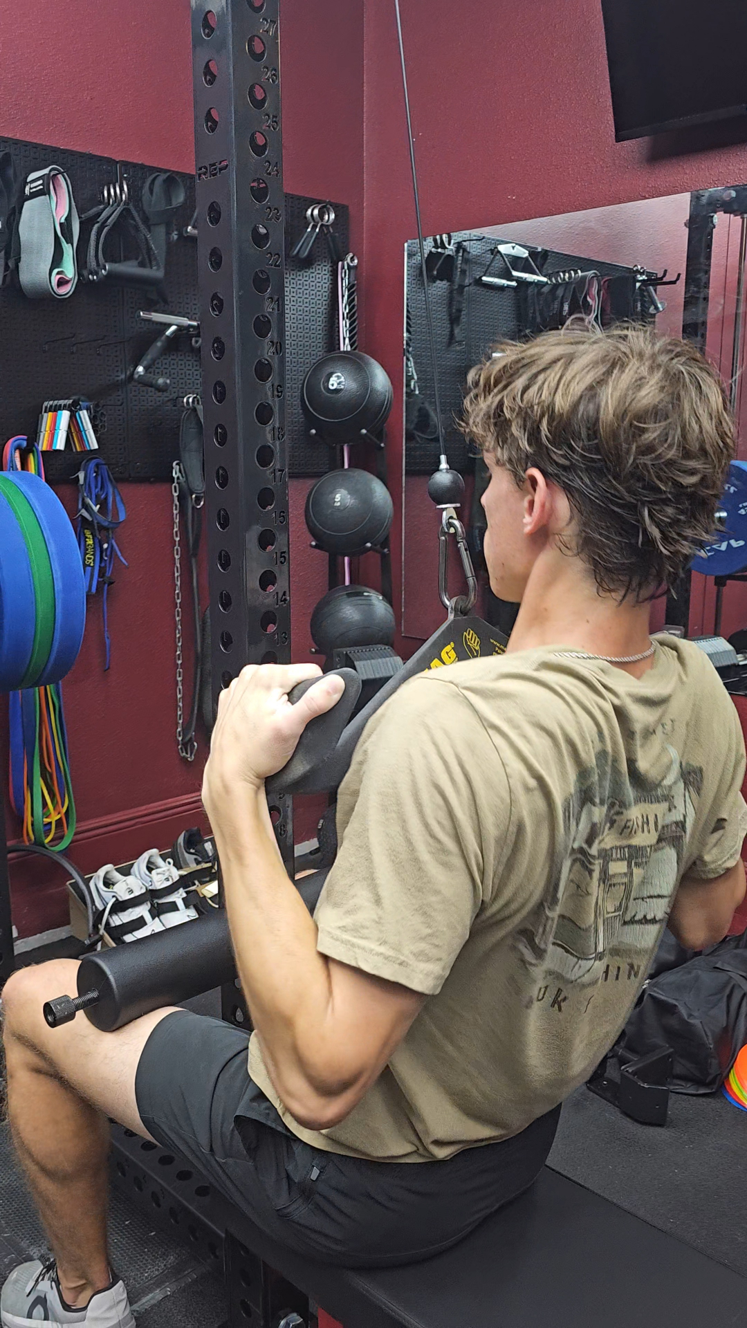 Athlete training with a squat machine at Power Stone Strength & Performance